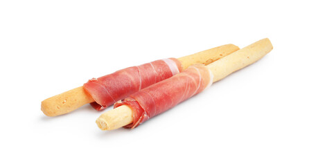 Delicious grissini sticks with prosciutto isolated on white