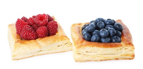 Yummy puff pastries with berries isolated on white