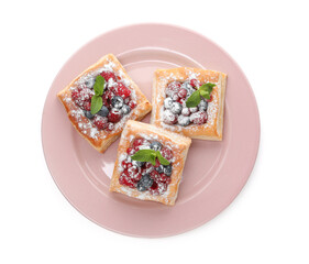 Tasty puff pastries with berries, powdered sugar and mint isolated on white, top view
