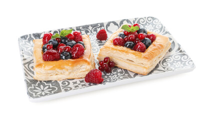 Tasty puff pastries with berries and mint isolated on white