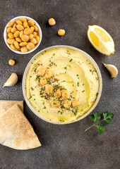 Lupini bean hummus with olive oil, herbs and pita bread on dark background. Vegetarian food.Top view