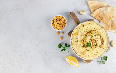 Lupini bean hummus with olive oil, herbs and pita on white background. Top view. Copy space. Vegan food.