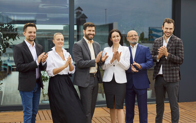 Fototapeta premium Applause of praise and recognition from confident people standing in line outside office. Acclaim and ovation from applauding happy colleagues, smiling coworkers in suits. Success, career concept