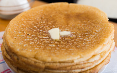 stack of appetizing flour pancakes in the kitchen during cooking