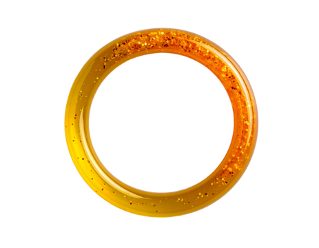 A golden ring, shimmering with embedded glitter, displays a smooth, polished surface and a translucent, slightly amber hue