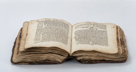 Old bible book with Hebrew text, open, isolated on white background