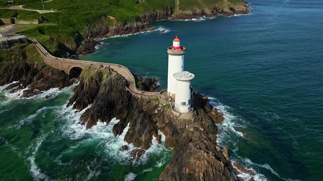 Petit Minou Lighthouse on rocky coast, France. Aerial drone orbiting