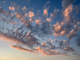 Clouds in the blue sky before sunset - background and texture