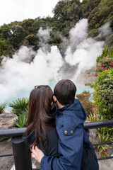 a mother and a child looking over the Sea Hell of Beppu, is known for its vibrant blue-colored and 98 degrees Celsius that use for cooking egg also known as Onsen Egg