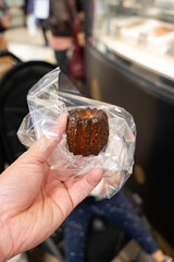 a well made chocolate caneles; a french pastry known for its crispy hard shell and soft custard taste inside