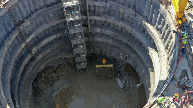 Aerial view of a massive circular construction site revealing concentric concrete rings and a ladder leading into the depths, Avc&Auml;&plusmn;lar, &Auml;&deg;stanbul, T&Atilde;&frac14;rkiye.