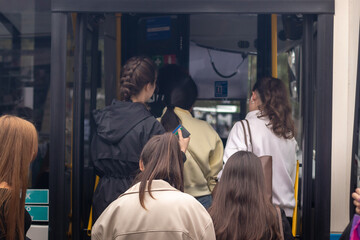 People boarding a bus. City life.