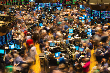 Dynamic motion blur captures the frenetic energy of a trading floor. Represents finance, investment, business, and economy. Ideal for illustrating highpressure environments.