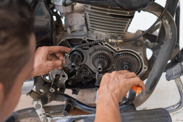 Fototapeta premium Mechanic working on motorcycle engine repair and maintenance