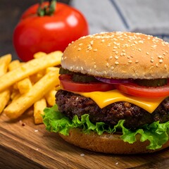 Close-up of a juicy cheeseburger with french fries