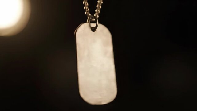 Lost Identity Silver Dog Tag Hanging in Dark Room, Close up View on Metallic Chain at Nighttime