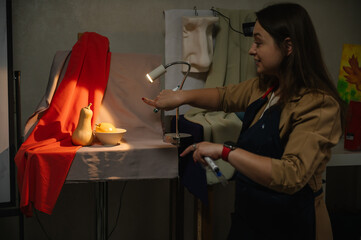 An artist explains how light falls on an object in an art class. Education and learning concept. Art lesson.