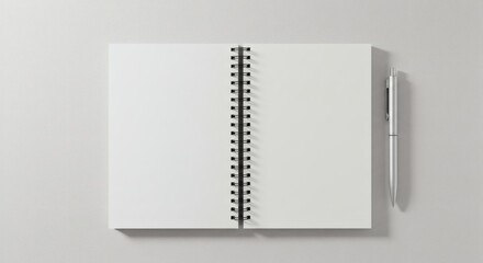 Top view of an open blank spiral notebook with white pages and a pen on a gray background for mockup design