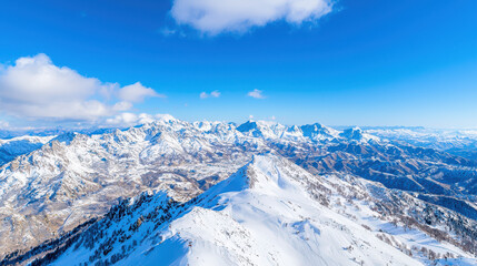 Fototapeta premium Breathtaking mountain landscape featuring snow covered peaks under clear blue sky, showcasing beauty of nature grandeur