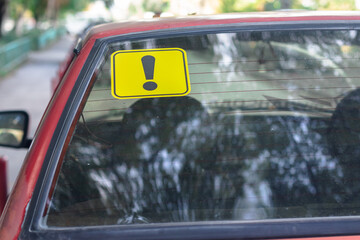 Fototapeta premium Warning yellow sticker with exclamation sign. Car driver newbie concept