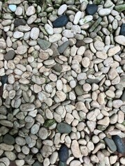 Close-up of a pile of small grey stones and pebbles, ideal for use in construction, landscaping, or natural texture design.