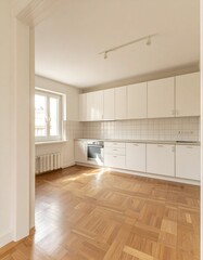 Empty bright white kitchen with light parquet floor