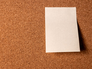 Fototapeta premium Blank white sheet of paper on cork board background for message or reminder