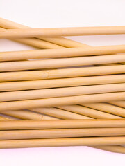 Close up of intertwined bamboo sticks with light background