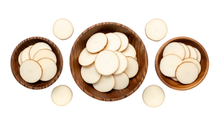 Wooden bowls filled with sliced, light-colored food circles