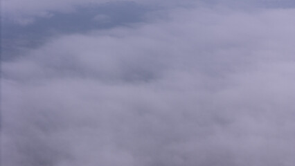Aerial of Village in rain cloud cover tropical green mountain. Rainy season. Misty cover green forest. beautiful green village