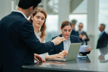 Outdoor working session of business professionals, collaboration and discussion emphasized, reflecting modern work culture at rooftop hotel.