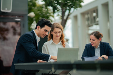 Professional group meeting outdoors, sharing ideas and solutions, representing teamwork, creativity, and business development culture at rooftop hotel.