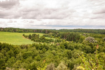 Mountain landscape with valley. Mountainous landscape with cloudy sky. Scenic green hill mountain. Breathtaking summer day in wild mountain with forest and green valley. Nature of forest