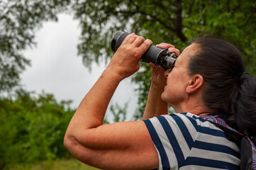 Observing nature. Woman explore environment. Woman ornithology expedition in forest. Hiker observing nature. Ornithology interesting occupation. Explore the environment. Bird watching tours