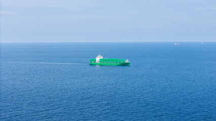 Green Cargo Container Ship, Cargo Container only green color. container ship running in the ocean to shipyard sea port. import shipping freight logistics. Concept green transportation environment