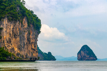 Limestone rocks hills turquoise blue water Phang Nga Bay Thailand.