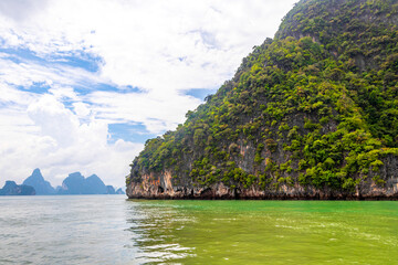 Limestone rocks hills turquoise green water Phang Nga Bay Thailand.