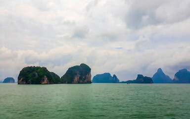 Limestone rocks hills turquoise blue water Phang Nga Bay Thailand.