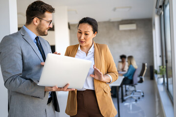 Group of young business people working as a team and communicating in corporate office