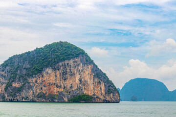 Limestone rocks hills turquoise blue water Phang Nga Bay Thailand.