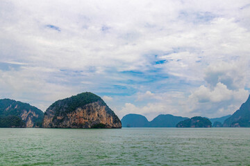 Limestone rocks hills turquoise blue water Phang Nga Bay Thailand.