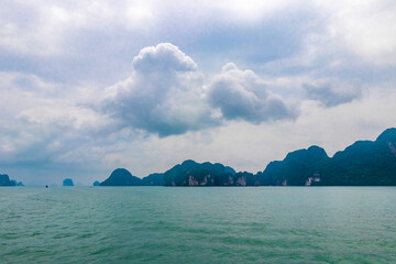 Limestone rocks hills turquoise blue water Phang Nga Bay Thailand.