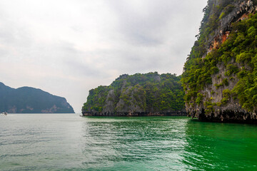 Limestone rocks hills turquoise green water Phang Nga Bay Thailand.