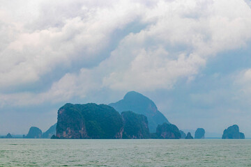 Limestone rocks hills turquoise blue water Phang Nga Bay Thailand.
