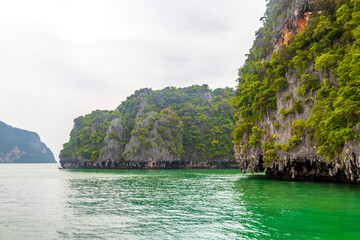 Limestone rocks hills turquoise green water Phang Nga Bay Thailand.
