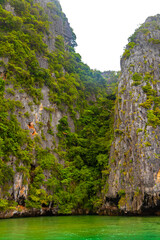 Limestone rocks hills turquoise green water Phang Nga Bay Thailand.