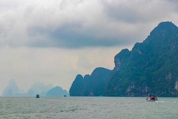 Limestone rocks hills turquoise blue water Phang Nga Bay Thailand.