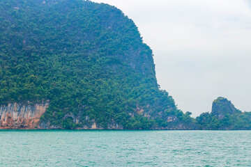 Limestone rocks hills turquoise blue water Phang Nga Bay Thailand.