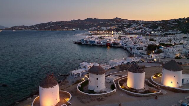 Night drone view of Greek village on an island in Aegean Sea, nightlife on Greek islands, travel in Greece