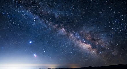 Stunning Milky Way Galaxy Arching Across a Dark Night Sky with Distant Horizon Glow.